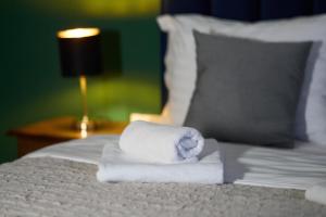 a pile of towels sitting on top of a bed at Nest & Rest Apartment Fast Wi-Fi Free Parking in Braşov +17 photos