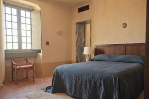 a bedroom with a bed and a chair and a window at Hôtel du Couvent, a Luxury Collection Hotel, Nice in Nice