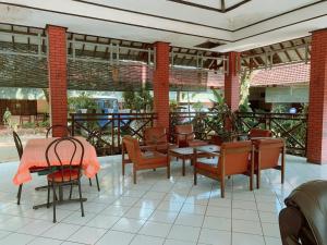 a restaurant with a table and chairs and a patio at Hotel Sala 1 Lempuyangan in Yogyakarta