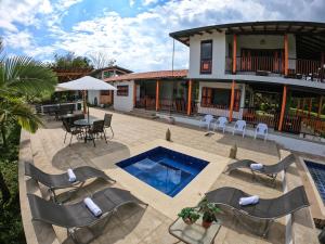 a house with a pool and chairs and a table at Finca La Coqueta Coffee Farm in Filandia