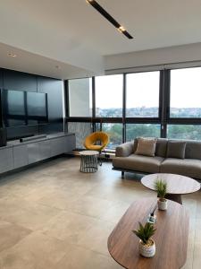 a living room with a couch and a table at Real Escal 1 bedroom at Airport Residential in Accra