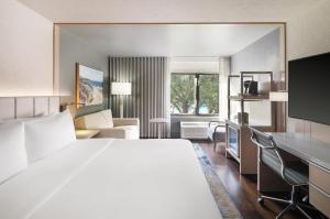 a hotel room with a large bed and a desk at Hotel Indigo Long Island - East End by IHG in Riverhead +36 photos