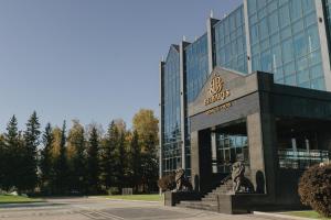 a building with a lion statue in front of it at Beibarys Hotel in Ustʼ-Kamenogorsk