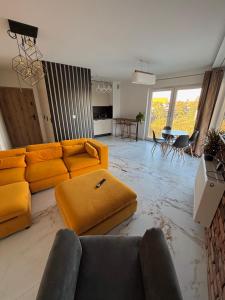 a living room with a couch and a table at Apartament nad Wartą Śrem in Śrem +11 photos
