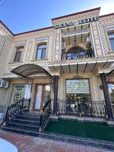 a large building with a staircase in front of it at Heart of Samarkand, main center in Samarkand