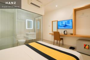 a hotel room with a bed and a bathroom at S79 Son Mi Hotel Saigon in Ho Chi Minh City