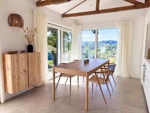 a dining room with a table and chairs and windows at The View - Wellness Forest Lodge in Stoumont +31 photos