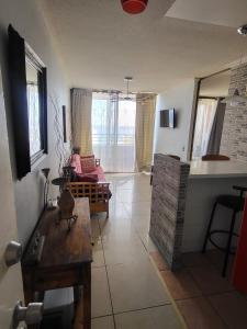 a living room with a couch and a table at Alojamiento Costazul2 in Iquique