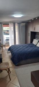 a bedroom with a large blue bed in a room at allen's place in Roodepoort