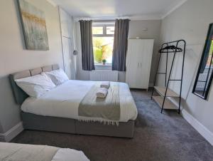 a bedroom with a large bed and a window at Lovely 2 Bedroom Getaway in Newcastle upon Tyne