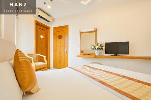 a bedroom with a bed and a tv on a wall at S79 Happy 7 Ly Thai To Street in Ho Chi Minh City