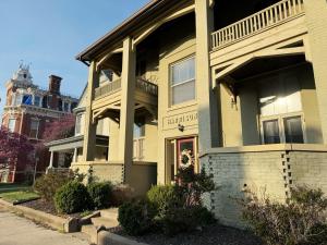 a large yellow house with a staircase on it at The Harrison Apartments in Evansville