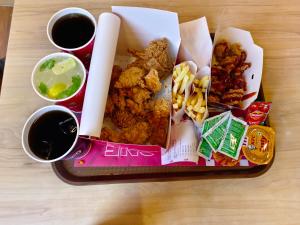 a tray of food with fried foods and drinks on a table at Hanni Resort in Kotagiri