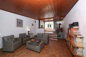 a living room with two couches and a table at Casa Tradicional Algarvia in Tavira