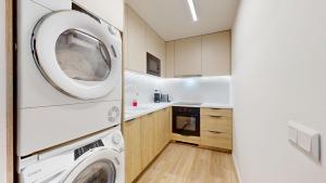 a laundry room with a washer and dryer at Downtown Apt w King Size Bed and AC in Bratislava +6 photos