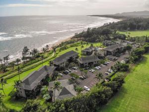 an aerial view of a resort next to the ocean at Kaha Lani 212 - Oceanfront 2BR Condo with Pool, Tennis & BBQs in Wailua
