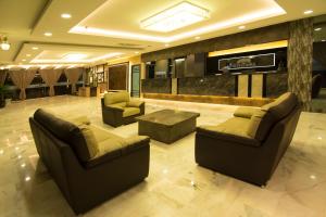 a lobby with two couches and a table in a building at Hotel Anika Kluang in Kluang