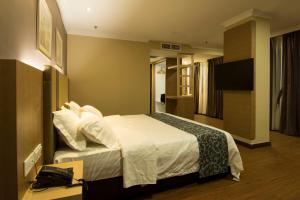 Postel nebo postele na pokoji v ubytování Hotel Anika Kluang