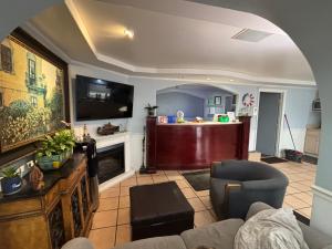 a living room with a couch and a tv at Hotel O Haven Inn Huntsville AL US 72 in Huntsville