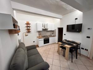 a living room with a couch and a table at SottoSopra Apartments - In centro a piedi in Ferrara +21 photos