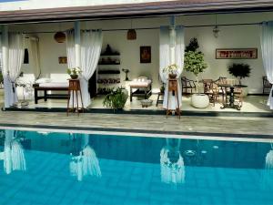 a house with a swimming pool in front of it at D' Art VILLA RETREAT AND SPA in Tangalle +184 photos
