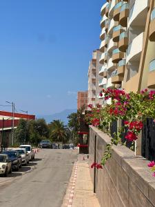 a city street with buildings and flowers on a wall at Dar Castiglione - Cosy duplex between Algiers and Tipaza in Bou Ismaïl
