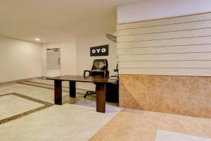 a office with a desk and a chair on a wall at HOTEL O ZOOM LUXURY STAY in Lonavala