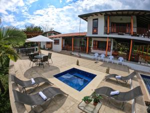 a patio with a pool and chairs and a house at Finca La Coqueta Coffee Farm Stay near Filandia in Filandia
