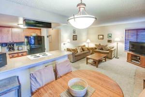 a kitchen and living room with a table and a couch at Fireside Pool Access Hot Tub & More in Mammoth Lakes +11 photos
