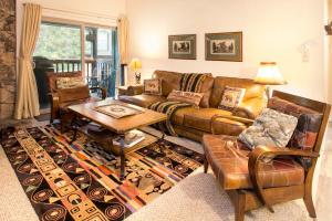 a living room with a couch and a table at Chamonix Year-Round Fun with Shared Pool in Mammoth Lakes +31 photos