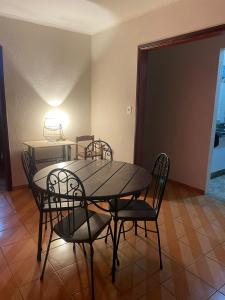 a dining room with a table and chairs at Casa tamanho Família Aconchegante in Bauru +21 photos