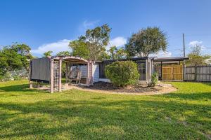 a house with a garden and a fence at Cozy Patio Retreat by SkyRun Jacksonville in Sandalwood