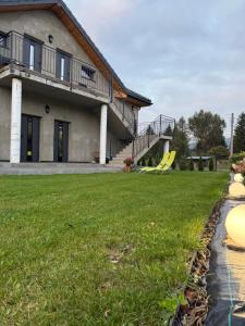 a house with a lawn in front of it at Apartamenty Polna Przystań in Stronie Śląskie +29 photos