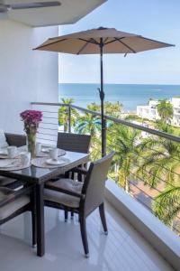 a dining room with a table and an umbrella at Ocean view - Studio in front of Nuevo Vallarta beach in Nuevo Vallarta 