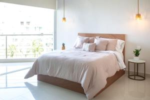 a bedroom with a bed with white sheets and a window at Ocean view - Studio in front of Nuevo Vallarta beach in Nuevo Vallarta  +33 photos