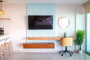 a bedroom with a bed and a desk with a chair at Ocean view - Studio in front of Nuevo Vallarta beach in Nuevo Vallarta 