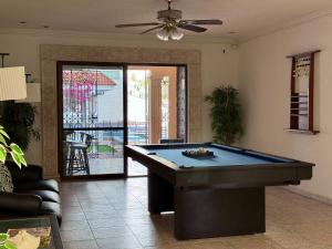 a living room with a pool table in it at Alojamiento para 6 personas con piscina in Chuburná de Hidalgo +28 photos