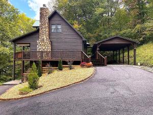 a log cabin with a porch and a driveway at Little Heaven in Young Harris