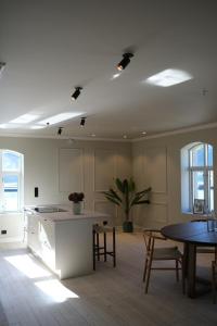 an empty room with a kitchen and a table at Large city apartment with sea view and parking in Ålesund +42 photos