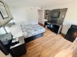 a hotel room with a bed and a television at Motel 6-Milford, CT in Milford