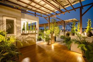 a patio with potted plants on a building at Royal Studio Golf Course Road in Gurgaon +93 photos