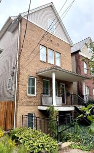a brick house with a porch and a balcony at Tremont Whole House in Cleveland