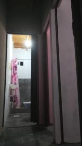 a bathroom with a sink and a pink doorway at Leo y mar in Mar de Ajó