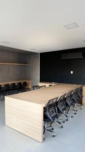 a conference room with a large table and chairs at Refúgio de Luxo in Montes Claros +80 photos