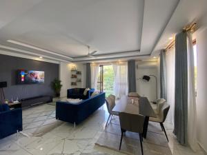 a living room with a couch and a table at Breeze Apartment in Mombasa