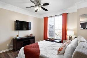 a bedroom with a bed and a flat screen tv at Relaxing Place Close to Skiing in Midvale