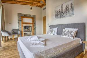 a bedroom with a large bed in a room at Aquaterra Hot Spring Villa - Banya in Banya +34 photos
