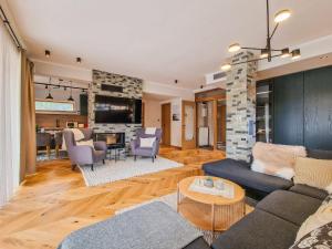 a living room with a couch and a table at Aquaterra Hot Spring Villa - Banya in Banya