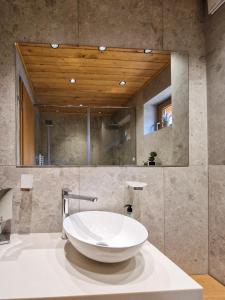 a bathroom with a large white bowl sink at Aquaterra Hot Spring Villa - Banya in Banya