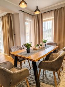 a dining room with a wooden table and chairs at Aquaterra Hot Spring Villa - Banya in Banya